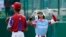 Aimar Lima (1) celebra parado en primera base después de conectar un hit en el juego de este domingo contra Cuba. (AP Photo/Tom E. Puskar)