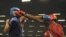 El cubano Lenier Pero (d) intercambia golpes con el argentino Yamil Peralta (i), durante su pelea de semifinales de los 91 kilogramos crucero de los Juegos Panamericanos 2011.